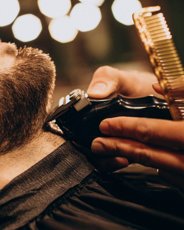 Handsome man at barbershop shaving beard